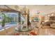 Elegant dining room showcasing a glass table with pool view, accented by a decorative chandelier and luxury finishes at 8832 Enclave Ct, Sarasota, FL 34238