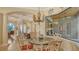 Charming dining area with decorative chandelier, glass table and outdoor view at 8832 Enclave Ct, Sarasota, FL 34238
