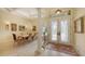 Formal dining room featuring a crystal chandelier and large front window at 8832 Enclave Ct, Sarasota, FL 34238