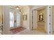 Grand foyer with decorative tile flooring and elegant double doors at 8832 Enclave Ct, Sarasota, FL 34238