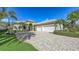 Charming home featuring a well-manicured lawn and spacious three-car garage at 8832 Enclave Ct, Sarasota, FL 34238