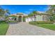 Beautifully landscaped home featuring a three-car garage at 8832 Enclave Ct, Sarasota, FL 34238