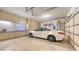 Spacious garage with ample storage cabinets, epoxy flooring, and room for parking with natural light at 8832 Enclave Ct, Sarasota, FL 34238