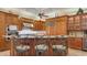 Gourmet kitchen featuring custom cabinetry, stainless steel appliances, granite countertops, and barstool seating at the island at 8832 Enclave Ct, Sarasota, FL 34238