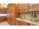 Kitchen detail featuring granite countertops, custom cabinetry, a stainless steel sink, and under-cabinet lighting at 8832 Enclave Ct, Sarasota, FL 34238