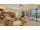 Bright and airy living room connecting the kitchen, dining, and outdoor pool area, perfect for entertaining at 8832 Enclave Ct, Sarasota, FL 34238