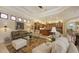 Open-concept living room featuring a large seating area, elegant décor, and access to the kitchen at 8832 Enclave Ct, Sarasota, FL 34238