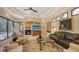 Cozy living room with a fireplace, entertainment center, comfortable seating, and view of the pool area at 8832 Enclave Ct, Sarasota, FL 34238