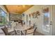 Covered outdoor dining area features bar, grill, TV and stone table, perfect for entertaining at 8832 Enclave Ct, Sarasota, FL 34238