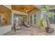 Covered patio featuring tiled floors, a ceiling fan, and lounge chairs perfect for relaxing in a private outdoor setting at 8832 Enclave Ct, Sarasota, FL 34238