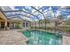 Sparkling screened pool with a spa and a stone patio perfect for outdoor entertaining and relaxation at 8832 Enclave Ct, Sarasota, FL 34238