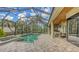 Screened in patio with an in-ground pool, spa and tiled flooring perfect for outdoor entertaining at 8832 Enclave Ct, Sarasota, FL 34238
