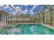 Inviting screened pool area with a spa, surrounded by lush landscaping for added privacy and relaxation at 8832 Enclave Ct, Sarasota, FL 34238