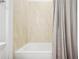 Neutral bathroom features a shower and tub with clean, light tile at 9566 Coastline Way, Parrish, FL 34219