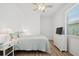 Comfortable bedroom with wood-look floors, a large window, and classic dresser furniture with a TV at 9566 Coastline Way, Parrish, FL 34219