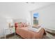 Cozy bedroom with large window, plush bedding, and soft natural light at 9566 Coastline Way, Parrish, FL 34219
