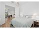 Comfortable bedroom with hardwood floors, an ensuite bathroom, and views into the dining area at 9566 Coastline Way, Parrish, FL 34219