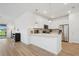 Open kitchen design with stainless appliances, breakfast bar seating, and pendant lighting at 9566 Coastline Way, Parrish, FL 34219