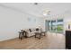 Spacious living room with wood floors, ceiling fan, and a view of the backyard patio and lake at 9566 Coastline Way, Parrish, FL 34219