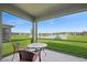 Enjoy serene lake views from this screened patio with comfortable seating area at 9566 Coastline Way, Parrish, FL 34219