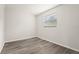 Light and airy bedroom featuring plank floors, white trim, and a modern window at 1008 37Th W St, Bradenton, FL 34205