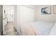 Comfortable bedroom with an open door and closet with view into the kitchen at 1008 37Th W St, Bradenton, FL 34205