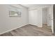 A light and airy bedroom with hardwood floors, modern closet and trim and a large window at 1008 37Th W St, Bradenton, FL 34205