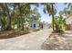 Well-maintained, single-story home with mature trees and a long driveway, providing ample parking space at 1008 37Th W St, Bradenton, FL 34205