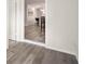 Hallway view into the kitchen showcasing flooring and lighting at 1008 37Th W St, Bradenton, FL 34205