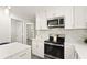 Well lit kitchen features stainless steel appliances and white cabinets at 1008 37Th W St, Bradenton, FL 34205