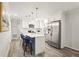A modern kitchen features white cabinets, stainless steel appliances, and an island with barstool seating at 1008 37Th W St, Bradenton, FL 34205