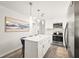 This kitchen includes stainless appliances, white cabinets and an island at 1008 37Th W St, Bradenton, FL 34205