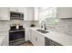 Close up of modern kitchen with stainless steel appliances and white cabinets at 1008 37Th W St, Bradenton, FL 34205
