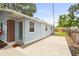 Side view of a light-blue house, showcasing a concrete patio and fenced backyard, perfect for outdoor living at 1008 37Th W St, Bradenton, FL 34205