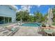 Backyard and patio area featuring a pool, lounge chairs, and dining table, perfect for enjoying the outdoors at 1076 Toc0Baga, Sarasota, FL 34234