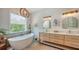 Serene bathroom with a freestanding tub, double sinks, and a contemporary design at 1076 Toc0Baga, Sarasota, FL 34234