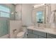 Bathroom featuring glass-enclosed shower and square mirror with gray vanity at 1076 Toc0Baga, Sarasota, FL 34234