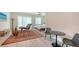 Bright bedroom featuring light wood flooring, accent rug, chaise lounge, and natural light from backyard windows at 1076 Toc0Baga, Sarasota, FL 34234