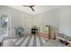 Bedroom with gray and white floor rug, neutral walls and wood ceiling fan at 1076 Toc0Baga, Sarasota, FL 34234
