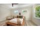 Bright bedroom featuring two windows, neutral tones, and wood-look floors at 1076 Toc0Baga, Sarasota, FL 34234