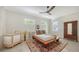 Bright bedroom with neutral decor, featuring a minimalist bed frame and wood-look floors at 1076 Toc0Baga, Sarasota, FL 34234