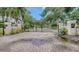Elegant gated entrance to a private community, featuring lush landscaping and architectural lighting at 1076 Toc0Baga, Sarasota, FL 34234