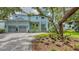 A bright, light blue two-story home with a paver driveway and an oversized 2-car garage at 1076 Toc0Baga, Sarasota, FL 34234