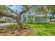 A bright, light blue two-story home with a paver driveway and an oversized 2-car garage at 1076 Toc0Baga, Sarasota, FL 34234