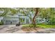 A bright, light blue two-story home with a paver driveway and an oversized 2-car garage at 1076 Toc0Baga, Sarasota, FL 34234