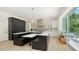 Gourmet eat-in kitchen featuring a large island with marble countertops and stainless hood at 1076 Toc0Baga, Sarasota, FL 34234