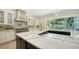 Modern kitchen with stainless steel appliances, a center island, and backyard pool at 1076 Toc0Baga, Sarasota, FL 34234