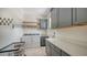 Laundry room with gray cabinets, white countertops, and a washer/dryer at 1076 Toc0Baga, Sarasota, FL 34234