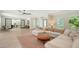 Bright and open living room with light tile floors, modern furniture, and abundant natural light at 1076 Toc0Baga, Sarasota, FL 34234