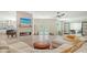 Spacious living room featuring fireplace, open floor plan and access to the pool area at 1076 Toc0Baga, Sarasota, FL 34234